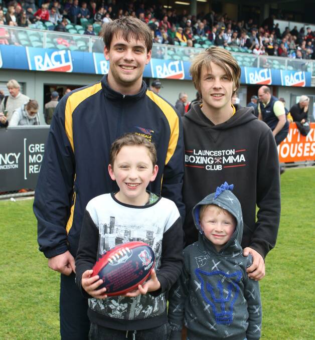 FAMILY AFFAIR: Dylan Wells, 19, and Bailey Wells, 15, with their cousins Callum Perry, 8, and Declan Perry, 5, all of Youngtown, at the TSL grand final. Picture: Holly Monery