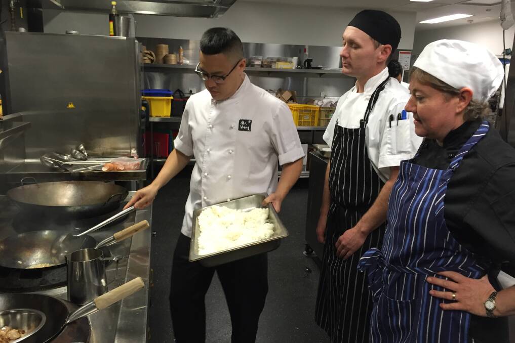 TEACHING MOMENT: Chef Dan Hong with third year students Sharon Cameron and Mark McClelland. Picture: Holly Monery.