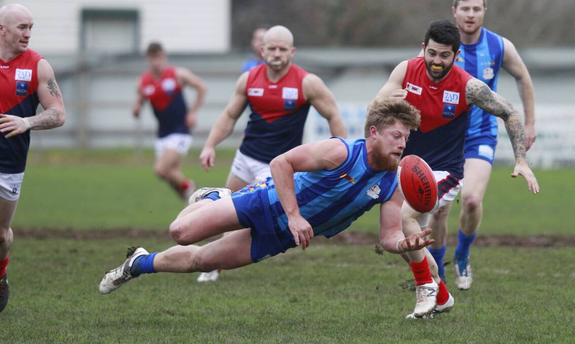 Another win slips away: Penguin's Jack Templeton loses his feet while trying to gather the ball in Saturday's NWFL match against Latrobe. Picture: Brodie Weeding.