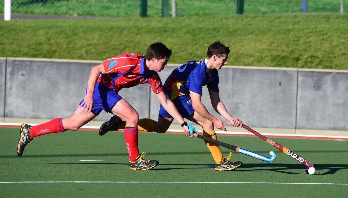 Pitch battle: Queechy's Finn Bailey (left) moves in on South Launceston's Kurt Budgeon in their GNL hockey match. Picture: Paul Scambler.
