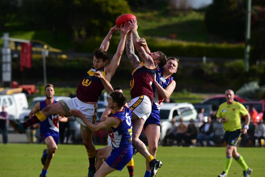 HANDS UP: A pack of players fight for the ball in last year's division 2 grand final. 