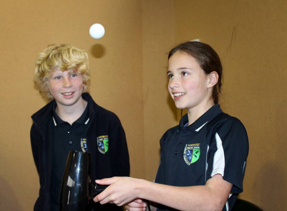 SCIENCE IS GOLDEN: Sophie Marston performs an experiment for Westbury Primary School's science expo as fellow grade 5 student Oliver Triffitt looks on. Picture: Hamish Geale 