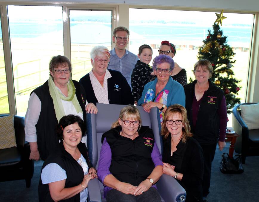 TAKE A SEAT: Advanced Life Care Company product consultant Simon Petrusma and Wilted Quilters members with the new aged care chair. Picture: Hamish Geale 