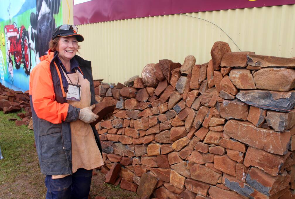 SET IN STONE: Mole Creek dry stone waller Lyn Stedman constructs a wall at the Tasmanian Craft Fair. Picture: Hamish Geale 