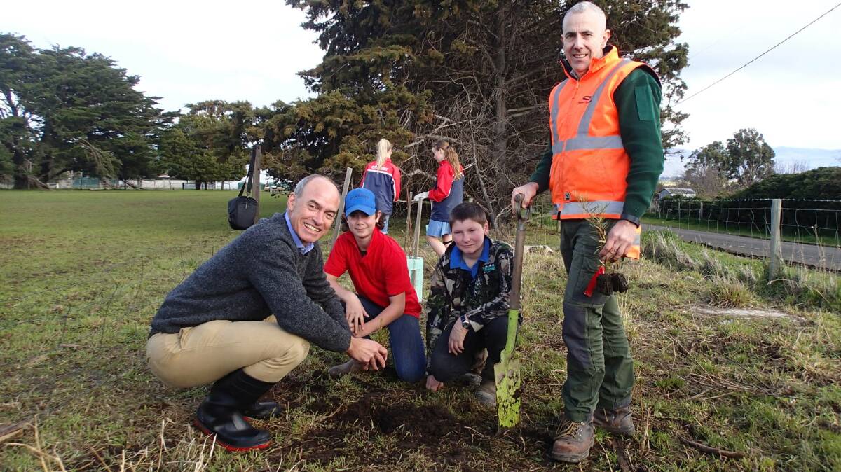 FROM LITTLE THINGS: Cressy District High School students Luke Bowerman and Henry Gibbons get into the spirit of Schools Tree Day with Resources Minister Guy Barnett and Forestry Tasmania nursery manager Peter Moore. Picture: Supplied 
 