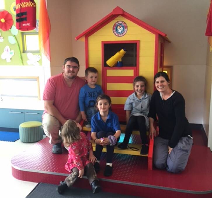 LIFE SAVERS: Sam and Mariah Terry inspect St Helens Playgroup's new cubby house with Hanisi, 8, Milly, 7, Chester, 4, and Annie, 2. Mr Terry won the cubby house for the playgroup by entering a Bunnings giveaway. Picture: Supplied 