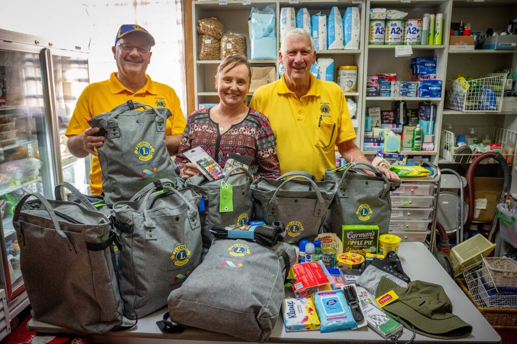 Riverside Lions Club duo Rod Peck and Brian Dunham and Shekinah House co-ordinator Louise Cowan. The club donated 50 backpacks for newly homeless people in Launceston. Picture by Paul Scambler