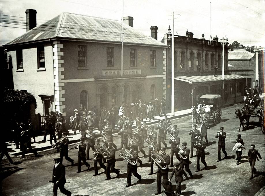 A band marches past the Star Hotel, opposite the Coach and Horses circa 1900. The Star
was built by John Sheridan in 1859, when he left the Coach and Horses, and still
there. Picture by Libraries Tasmania, LMSS725-1-28