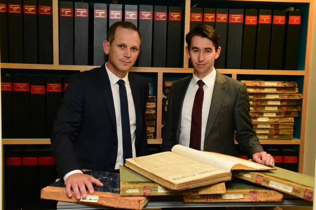 MILESTONE: Fairfax Tasmania group sales manager Dan Ryan and group managing editor Mark Baker inspect an 1842 edition of The Examiner.