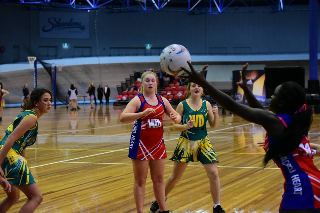 INCOMING: Sacred Heart goal shooter Rose Michael rakes in a pass from teammate Siobhan Smith in the grand final clash with St Patrick's College. Pictures: Paul Scambler