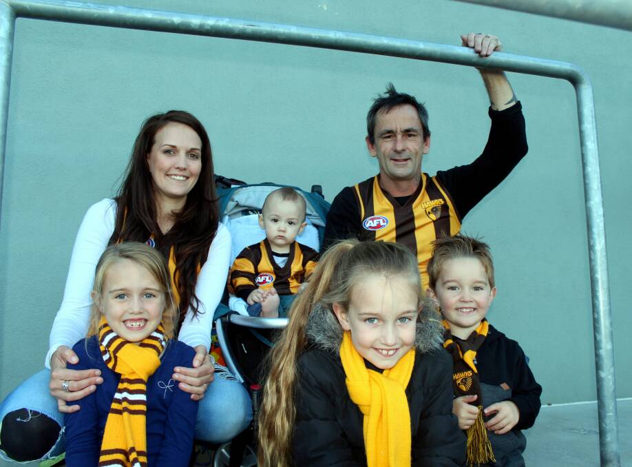 HAPPY HAWKS: Shilah Lockwood, 6, Hanna Parker, Ace Rigby, 11 months, Tamiya Lockwood, 8, Dale Rigby and Xander Lockwood, 3, attend Hawthorn's training session on Friday. Picture: Hamish Geale 
