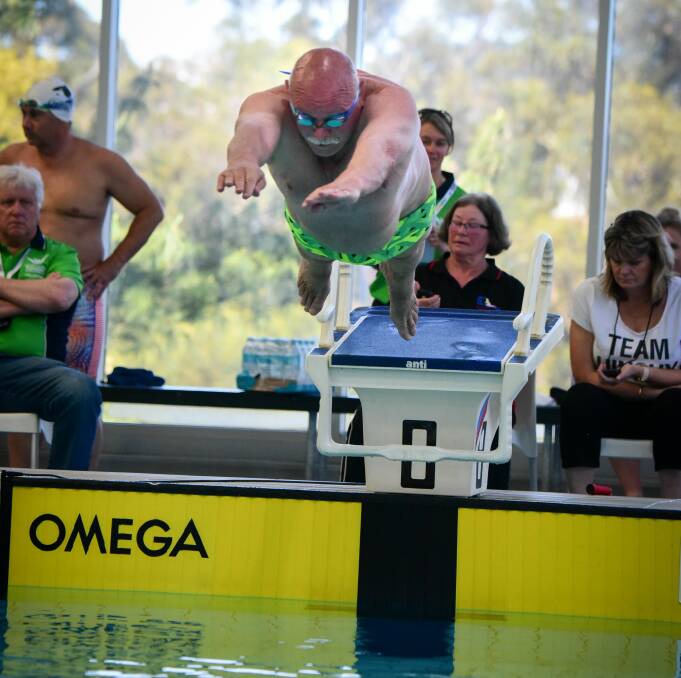 MID-AIR: Tonkin dives into the pool.