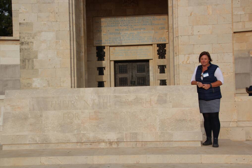 CARVED IN STONE: Mrs Burt at the Jerusalem War Cemetery. Pictures: Supplied