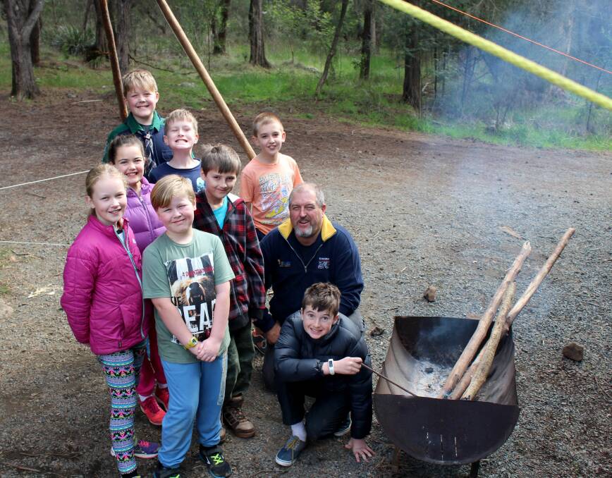 SCOUT SQUAD: Summerhill scout leader Trevor Parker instructs the next generation in building a campfire at a scout camp earlier this month. The Summerhill group is on the lookout for a new cub leader. Picture: Hamish Geale