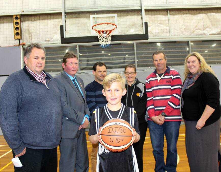 NET RESULT: Deloraine junior basketballer Caleb Atkins after taking the first shot at Deloraine Community Complex's new rings, with Heath Butt, Michael Kelly, Shaun Donohue, Kellie Haberle, Tony Skipper and Laura Richardson.
