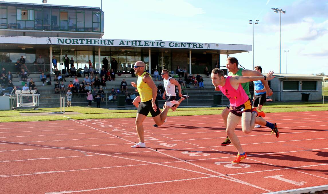 ALL YELLOW: Hobart sprinter Mark Nicholls pips open 70m winner Brendan Smart in the 120m men's gift. Pictures: Hamish Geale