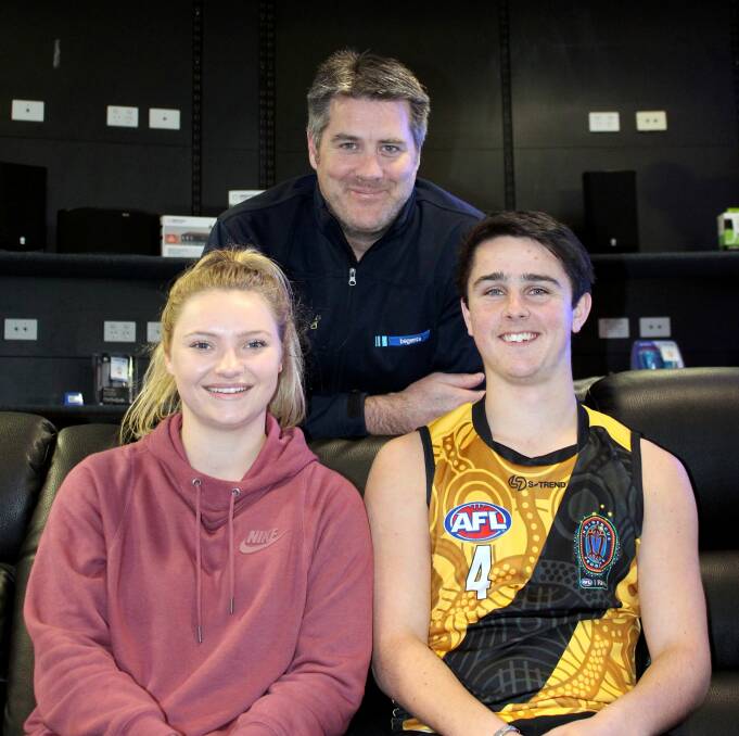 LEAPS AND BOUNDS: Community Housing Ltd scholarship holders Daria Bannister and Callum Harrison with Begents personnel officer Chris Hills. Picture: Hamish Geale