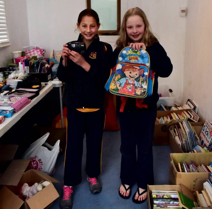 SWIM TEAM: Jasmine Irani, 11, and Isabella Muldoon, 10, help out at Launceston Aquatic Club's Garage Sale Trail fundraiser. Picture: Neil Richardson