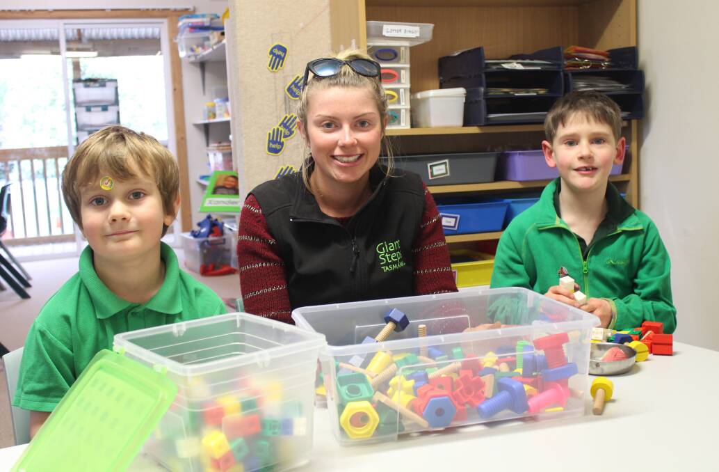 BUILDING BLOCKS: Giant Steps therapy assistant Heidi Walker spends some time with students Elliott Bartninkaitis, 6, and Logan Szoka, 8. The school is set to receive between $10,000 and $20,000 from this year's Deloraine Craft Fair. Picture: Hamish Geale