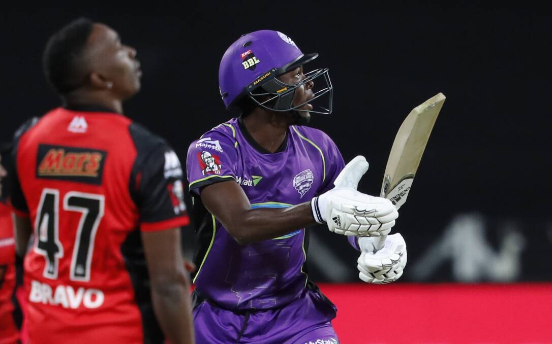 WHERE'S THAT GONE: Jofra Archer hits the ball away to the leg side as Melbourne Renegade Dwayne Bravo looks on. Picture: AAP