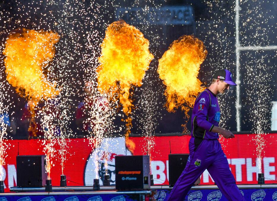 BATTLEFIELD BLAZE: Hobart Hurricanes captain George Bailey enters the field of play Big Bash style - amidst jets of fire. Picture: Scott Gelston