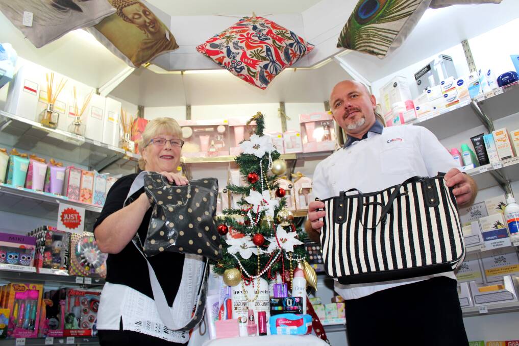 CHRISTMAS COLLECTION: Donor Rosemary Launder and West Tamar Pharmacy owner Borys Szydlowski prepare for Share the Dignity's It's in the Bag campaign. Picture: Hamish Geale 