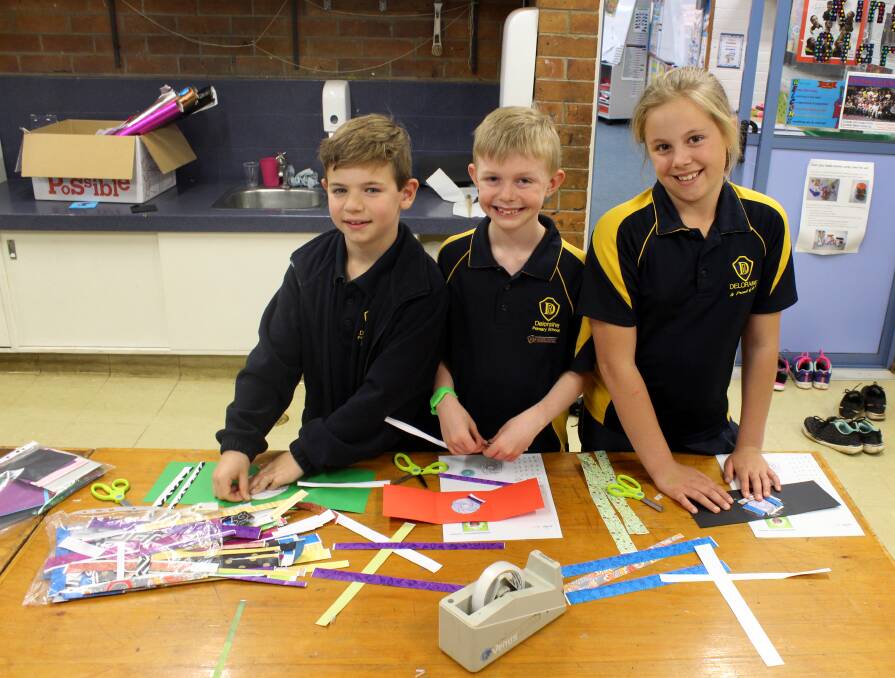 ON THE CARDS: Deloraine Primary School students Isaac Bramich and Alex Norton (grade 3) and Danika McCabe (grade 4) make iris folding cards for November's school fair. Picture: Hamish Geale  