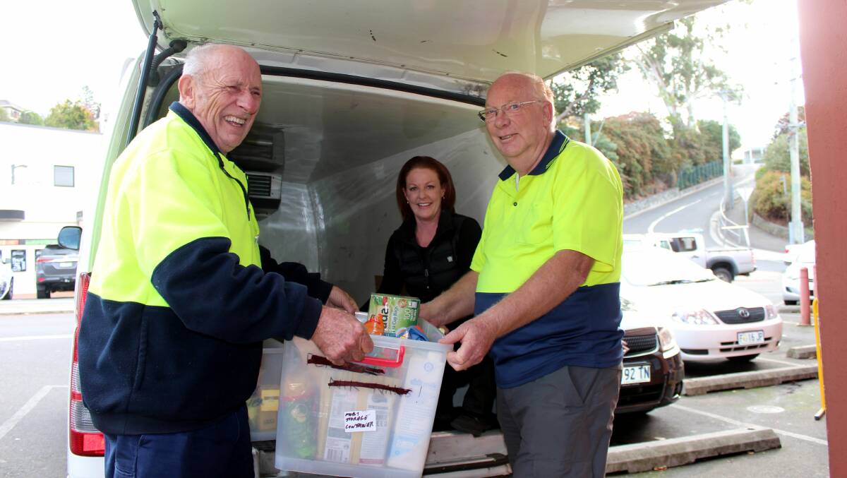 ON A MISSION: Trevallyn Newsagency's Cathie Lewis helps City Mission volunteers Paul Thomas and Lionel McInnes load non-perishables into a van for Mission Possible. Picture: Hamish Geale