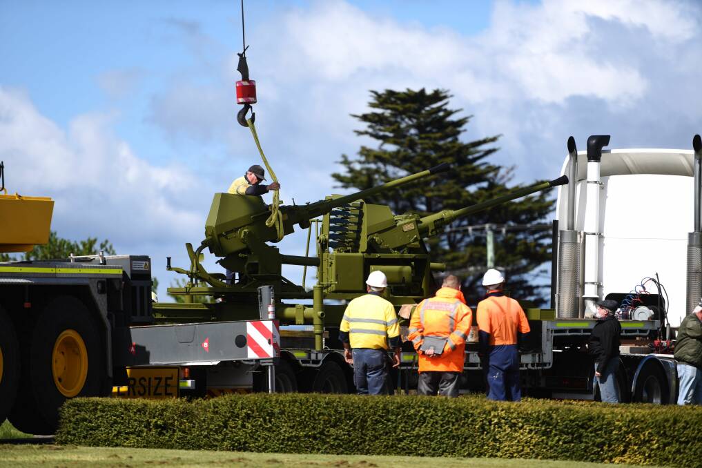 A crane lifted two refurbished bofor guns into their new homes at Max Harris Memorial Reserve on Tuesday morning. Pictures: Scott Gelston