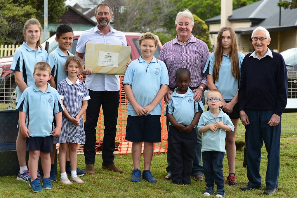 SPANNING GENERATIONS: BCDA president Michael Symons, 1960s head teacher Roger Dixon and tourism pioneer Brian Winspear meet student leaders Cassie Silberberg, Morgan Evans, Fionn Sinclair and Larna Malle, and kindergarten students Sam Williams, Lucie Ackers, Bertrand Omenka and Charlie Hunter-Marriott at the school's time capsule ceremony. 