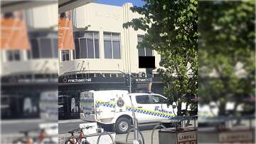 An alleged juvenile offender atop a police car in the Launceston mall last year. Picture supplied