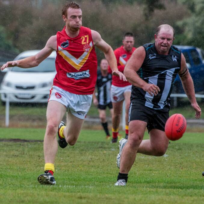 IN PURSUIT: Meander Valley's Joel Thompson braces to bump Ben Barry off the ball. 