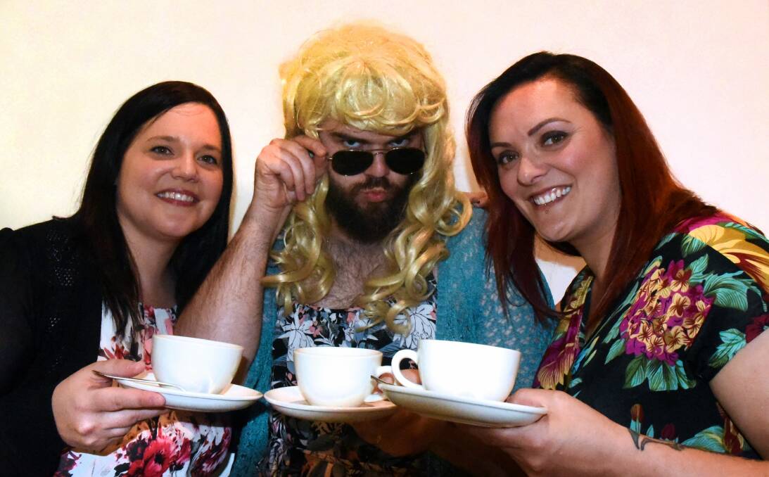 FROCK ON: Jane Taylor, 'Sharon Simons' and Katy Pakinga share a cuppa at Sunday's ovarian cancer fundraiser. Picture: Neil Richardson 