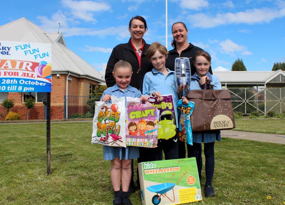 FAIR GO: Perth Primary School Fair organisers Mel Swindells and Bec Barnes get ready for the big day with students Hayley Barnes, 7, Caden Swindells, 10, and Michaela Swindells, 8. Picture: Hamish Geale 