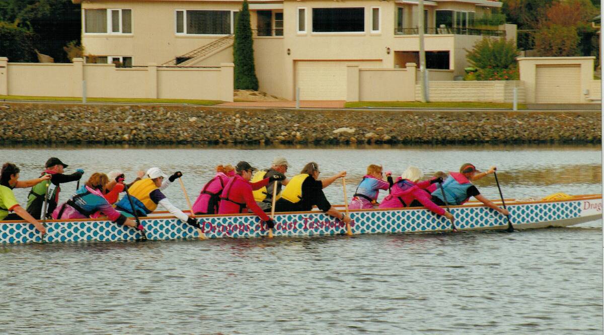 TEAMWORK: Georges Bay Dragon Boat Club members Dina McGuinness and Geoff Butler (in yellow) train with Hobart Dragons Abreast earlier this year. Picture: Supplied 
