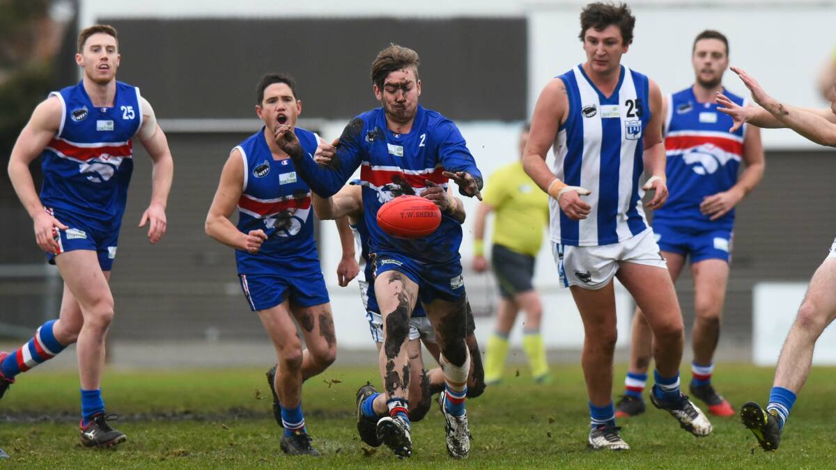 DIRTY DAY: A muddied South Launceston midfielder Jordan Tepper breaks clear from his Deloraine opponents in the middle of Youngtown Oval. Picture: Neil Richardson 