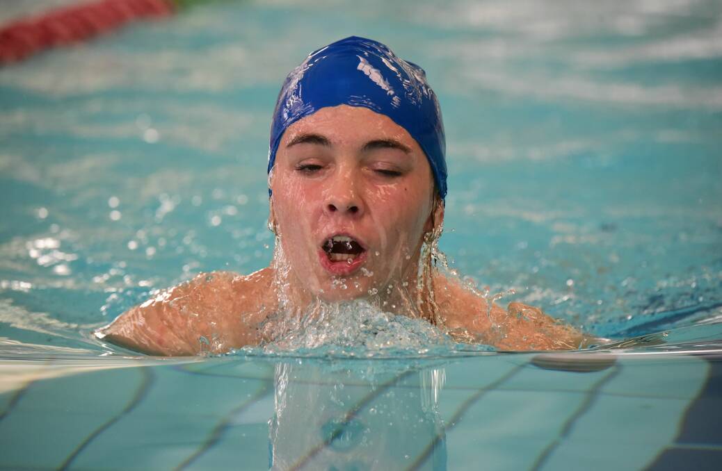 Grade 8 swimmer Emily Kalos mid-breaststroke.