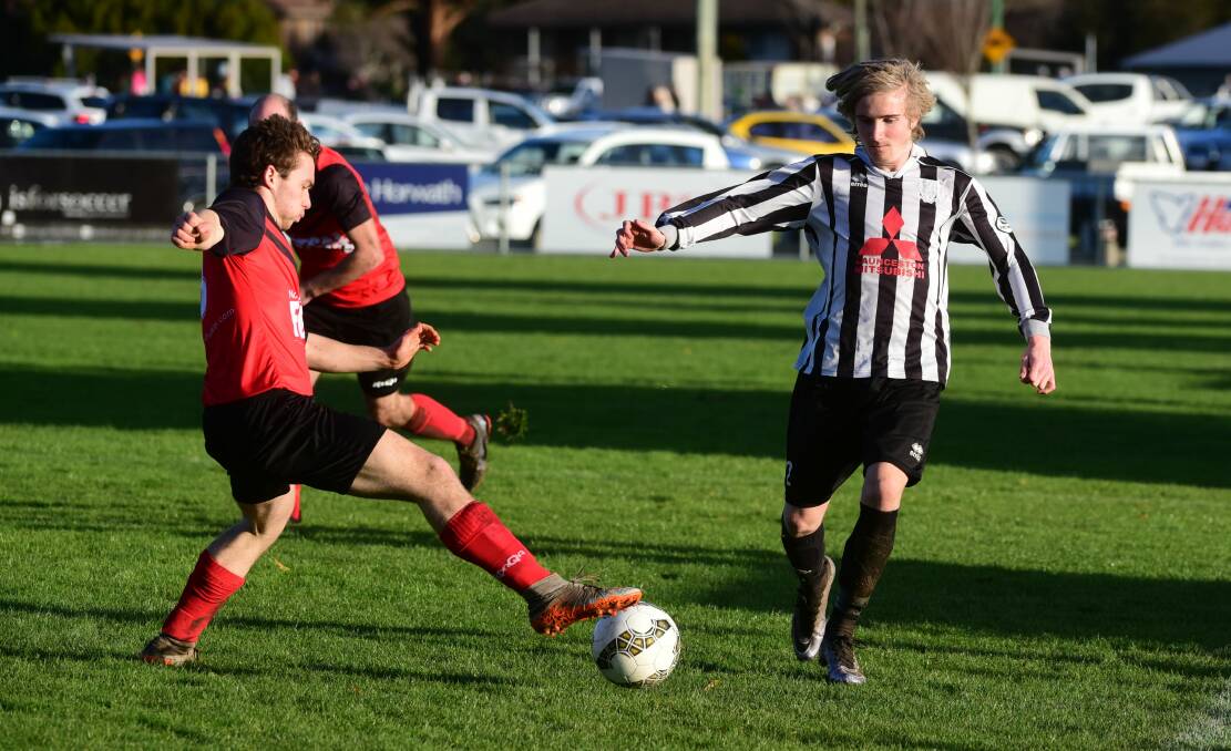 Launceston City's William Rodman and Ulverstone's Cosmo Cox-Haines dual for the ball.