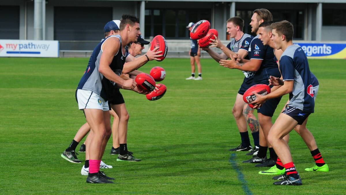 FIRED UP: Launceston players warm up at training.