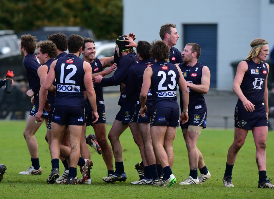 GET AROUND HIM: Jacob Boyd's Launceston teammates celebrate a goal he kicked in his senior debut at Windsor Park against Tigers last season. Boyd will line-up in the Blues' development league grand final side on Saturday.