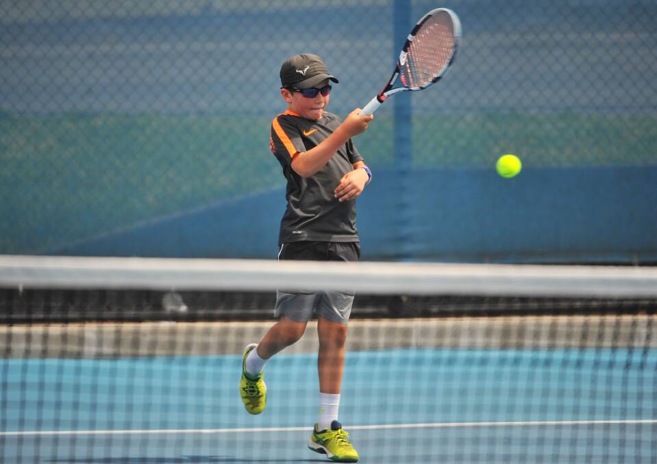 SHOT: George Anderson returns a ball in the 11 and under boys final.