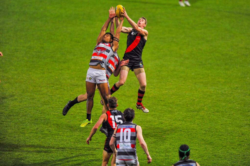 BANNED BOMBER: Lauderdale's Toutai Havea in a marking contest with North Launceston's Bart McCulloch at UTAS Stadium on Saturday. He will miss this weekend's preliminary final through suspension. Picture: Scott Gelston