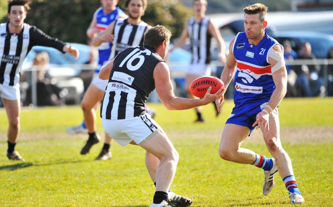 HUNTER: South Launceston defender Joel Mountney closes in on Magpie Lee Nichols during the first semi-final. Picture: Scott Gelston 