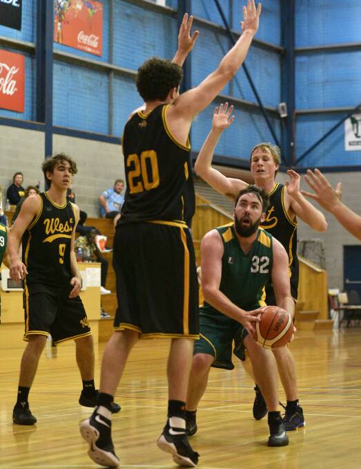 HEAVY TRAFFIC: Tasmania's Raymond Young is blocked in the Baptist Basketball grand final between Tasmania and Western Australia. Picture: Scott Gelston