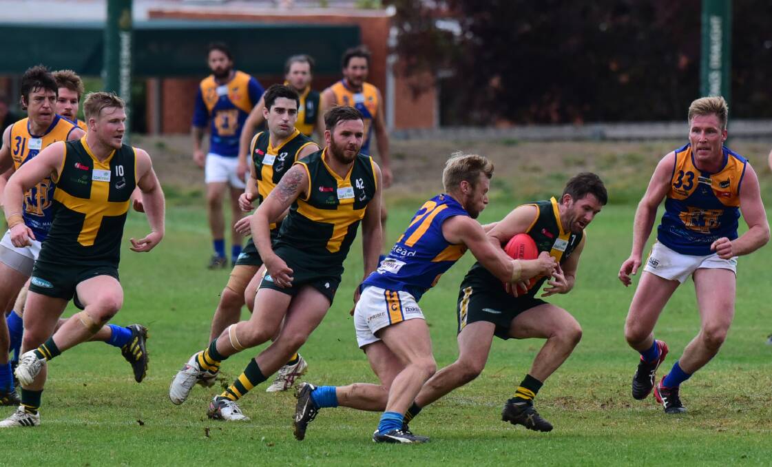 TACKLE: Evandale's Jason Bennett grabs St Pats' Brad Pearton during the Saints' eight-point win on Saturday. Picture: Paul Scambler.