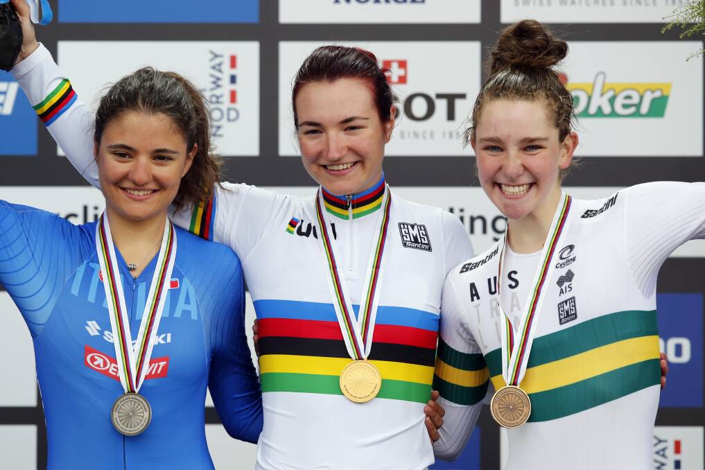 First-placed Elena Pirrone, of Italy, second-placed Alessia Vigilia, of Italy and third-placed Madeleine Fasnacht, of Australia, celebrate with their medals after the UCI cycling road world championships women's junior individual time trial in Bergen, Norway. Picture: AP