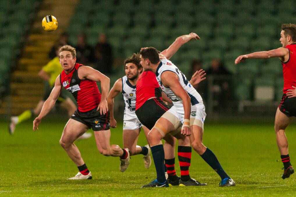 WATCHFUL: North Launceston coach Tom Couch looks to collect a centre clearance against the Bombers' old foes Launceston at UTas Stadium on Friday night. Picture: Phillip Biggs