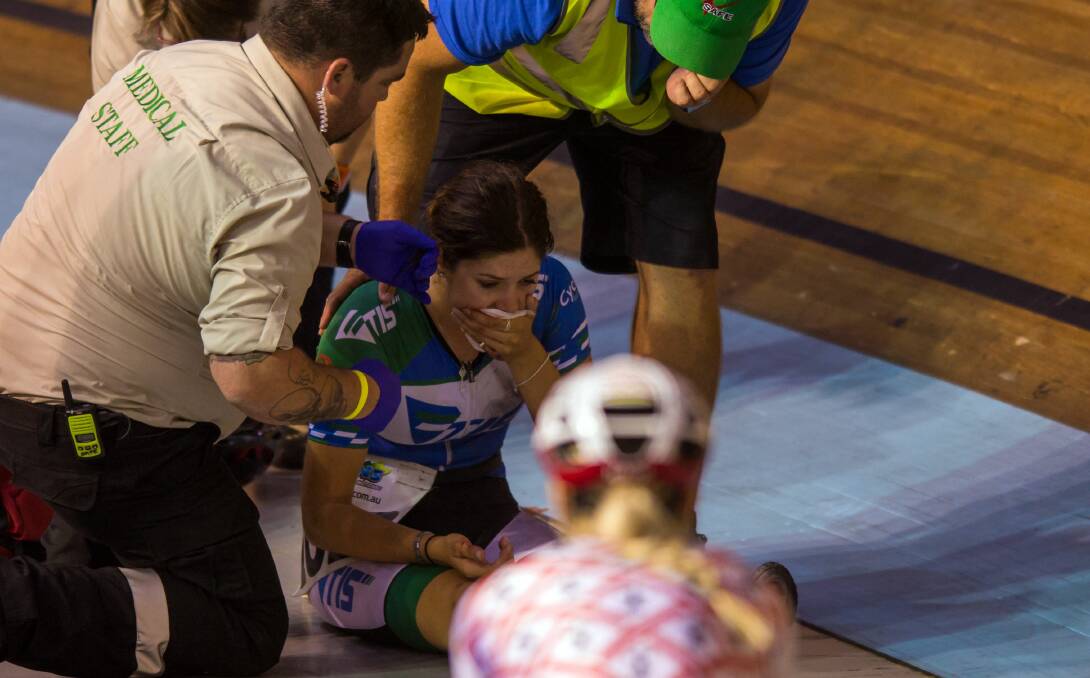 OUCH: Perth's Georgia Baker receives medical treatment after clipping wheels with Annette Edmondson and crashing heavily in the Launceston Carnival at the Silverdome. Picture: Phillip Biggs