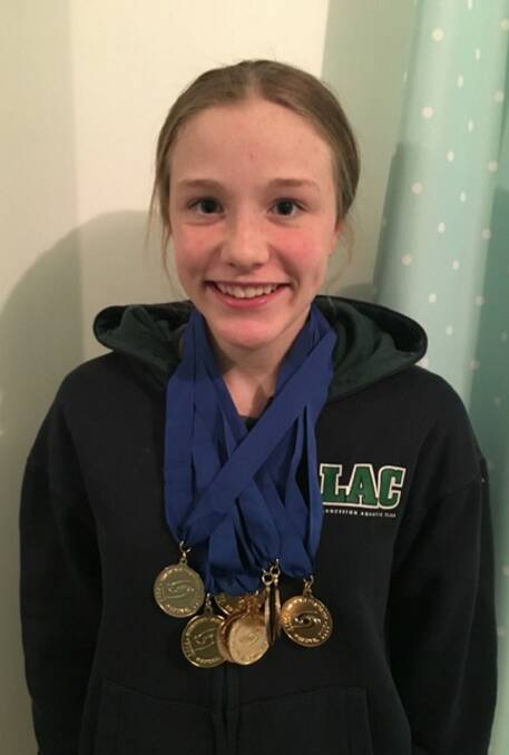 Golden girl: Chelsea Savage, 13, of Launceston, with her medal haul from the Northern regional swimming championships.