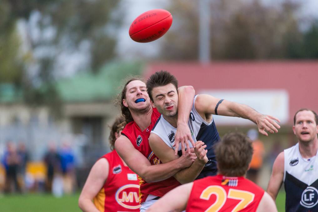 GOTCHA: Suns Ethan Miller grabs Old Launcestonian Tyler Williams around the neck at Invermay Park on Saturday afternoon. Picture: Phillip Biggs